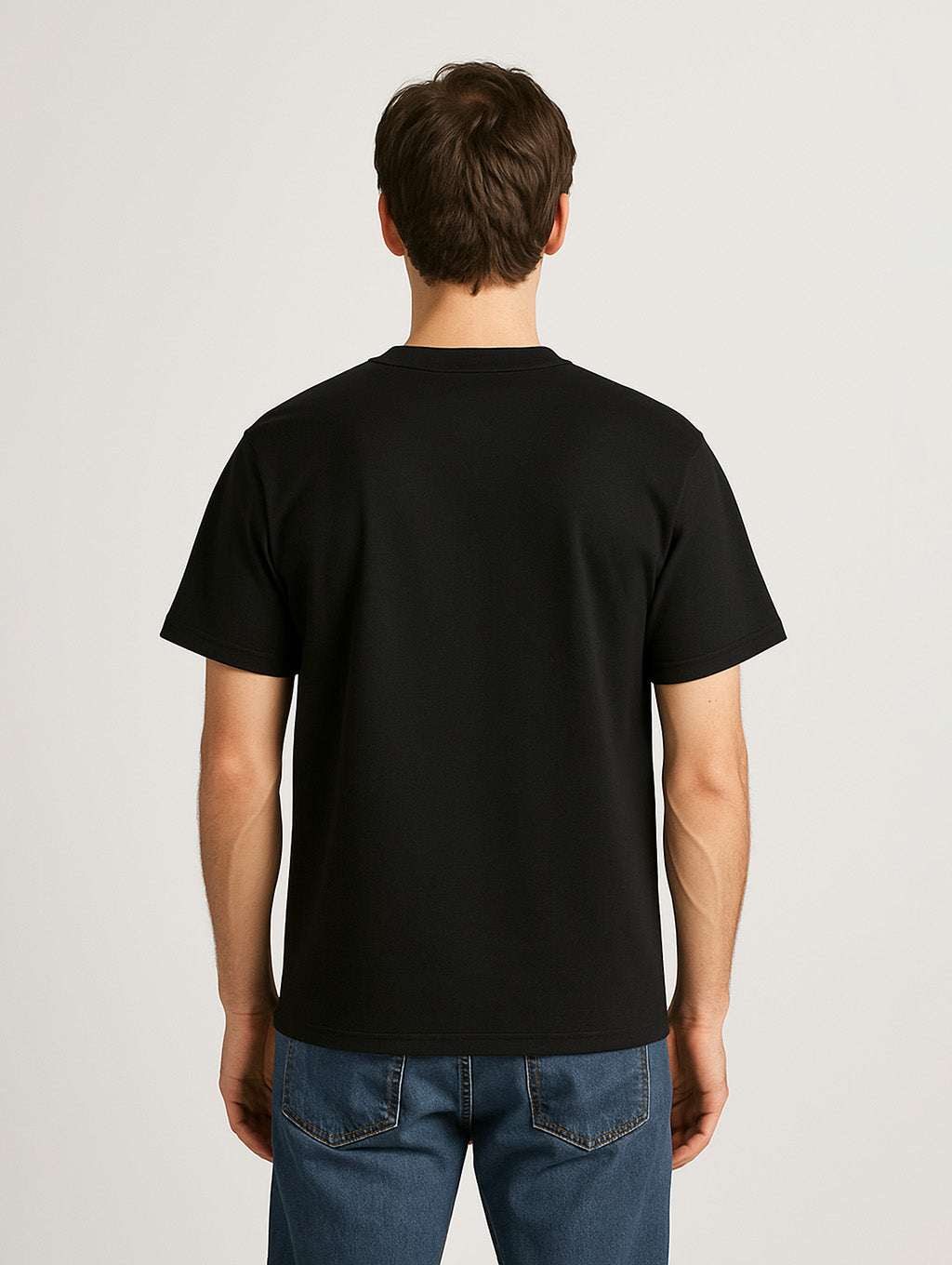 Back view of male model wearing Zarvion Premium Tee in black – regular fit