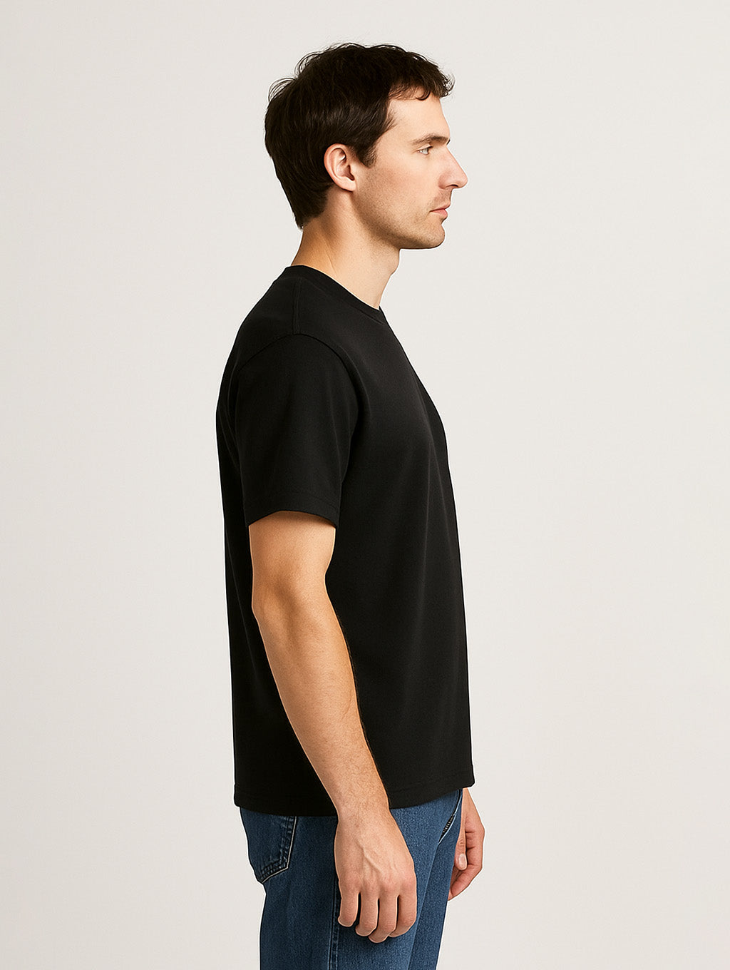 Side view of male model wearing Zarvion Premium Tee in black – timeless silhouette