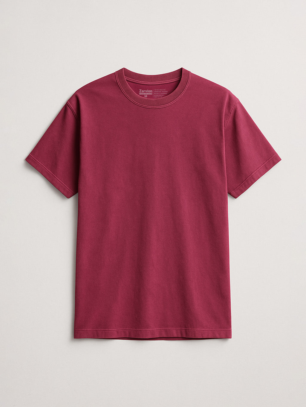 Flat lay of Berry vintage tee by Zarvion – short sleeve relaxed fit shirt on neutral background