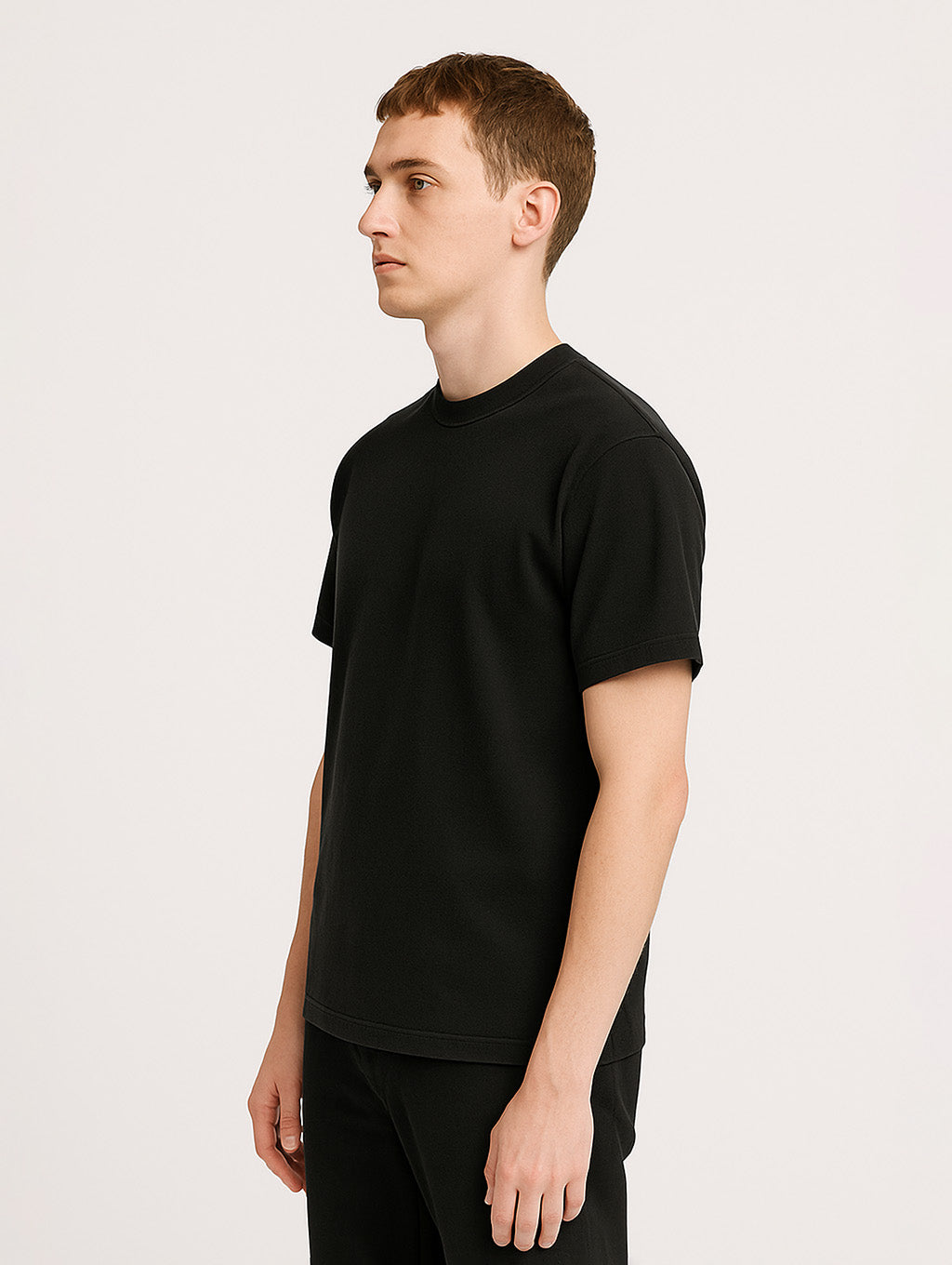 Side profile of model in Black Zarvion tee – structured fit, garment-dyed heavyweight cotton