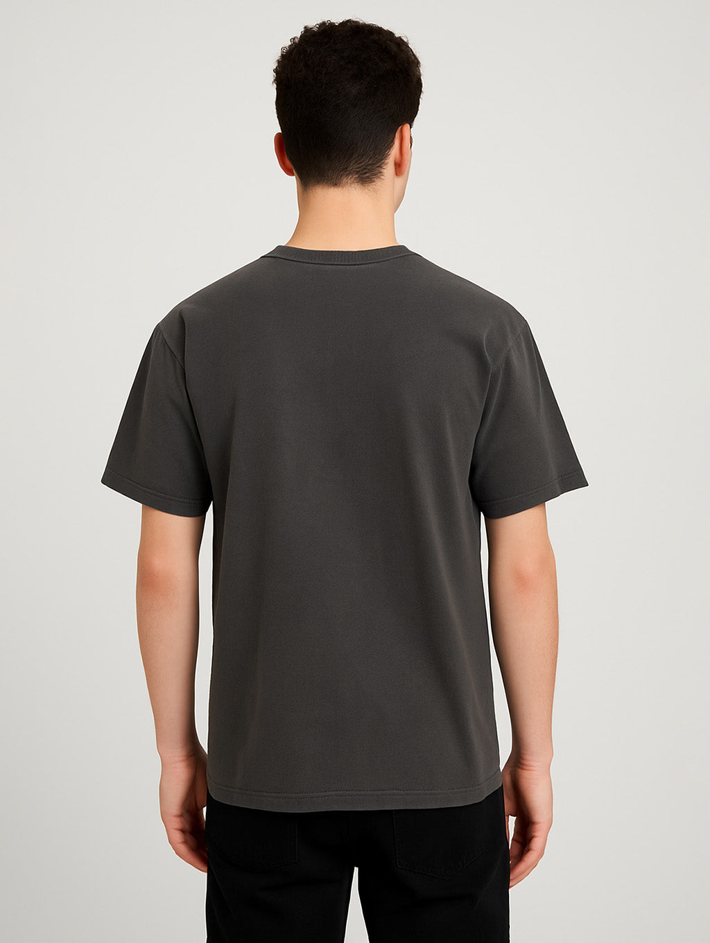 Back view of male model wearing Zarvion Charcoal vintage t-shirt – relaxed streetwear fit