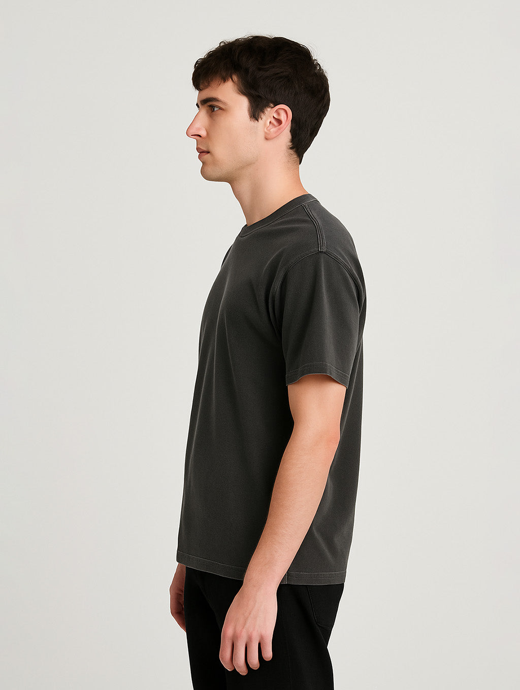 Side profile of male model in Charcoal Zarvion t-shirt – heavyweight cotton, relaxed silhouette