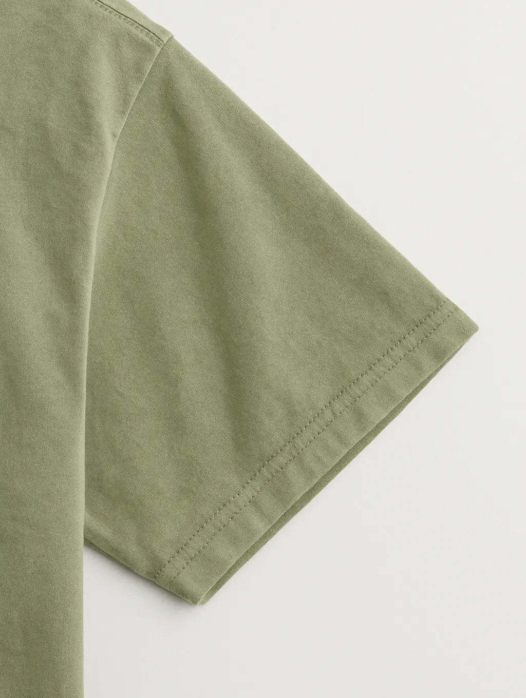 Close-up sleeve hem of Dusty Olive Zarvion vintage tee – double-needle stitching on heavyweight fabric