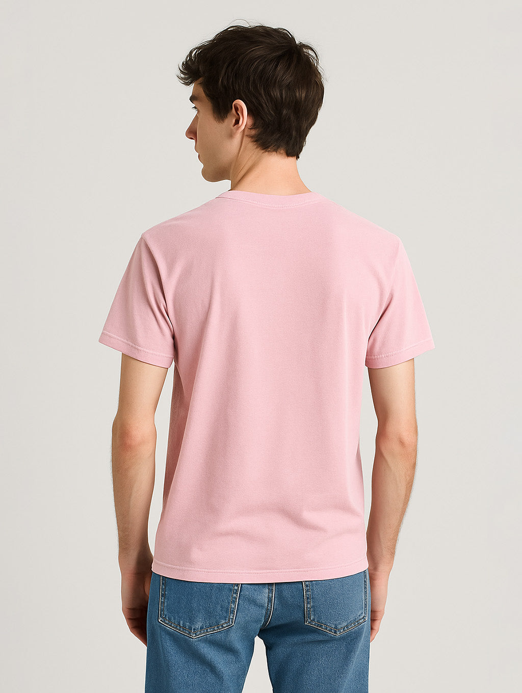 Back view of slim male model wearing Zarvion Blush Blossom Pink vintage t-shirt – clean streetwear