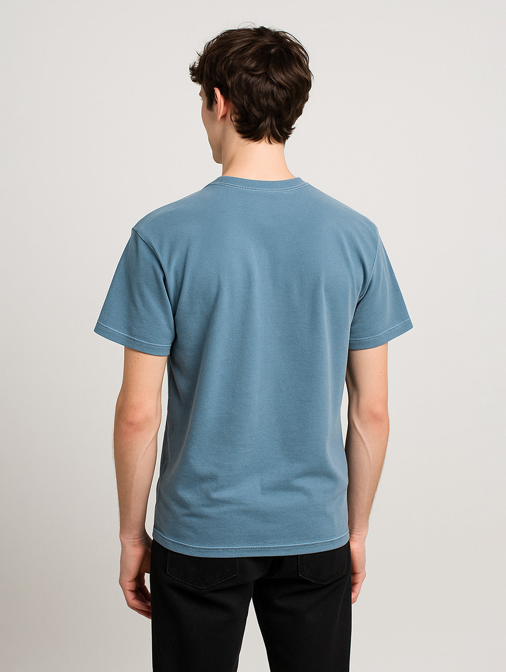 Back view of slim male model wearing Worn Denim Blue Zarvion vintage t-shirt – relaxed structured fit