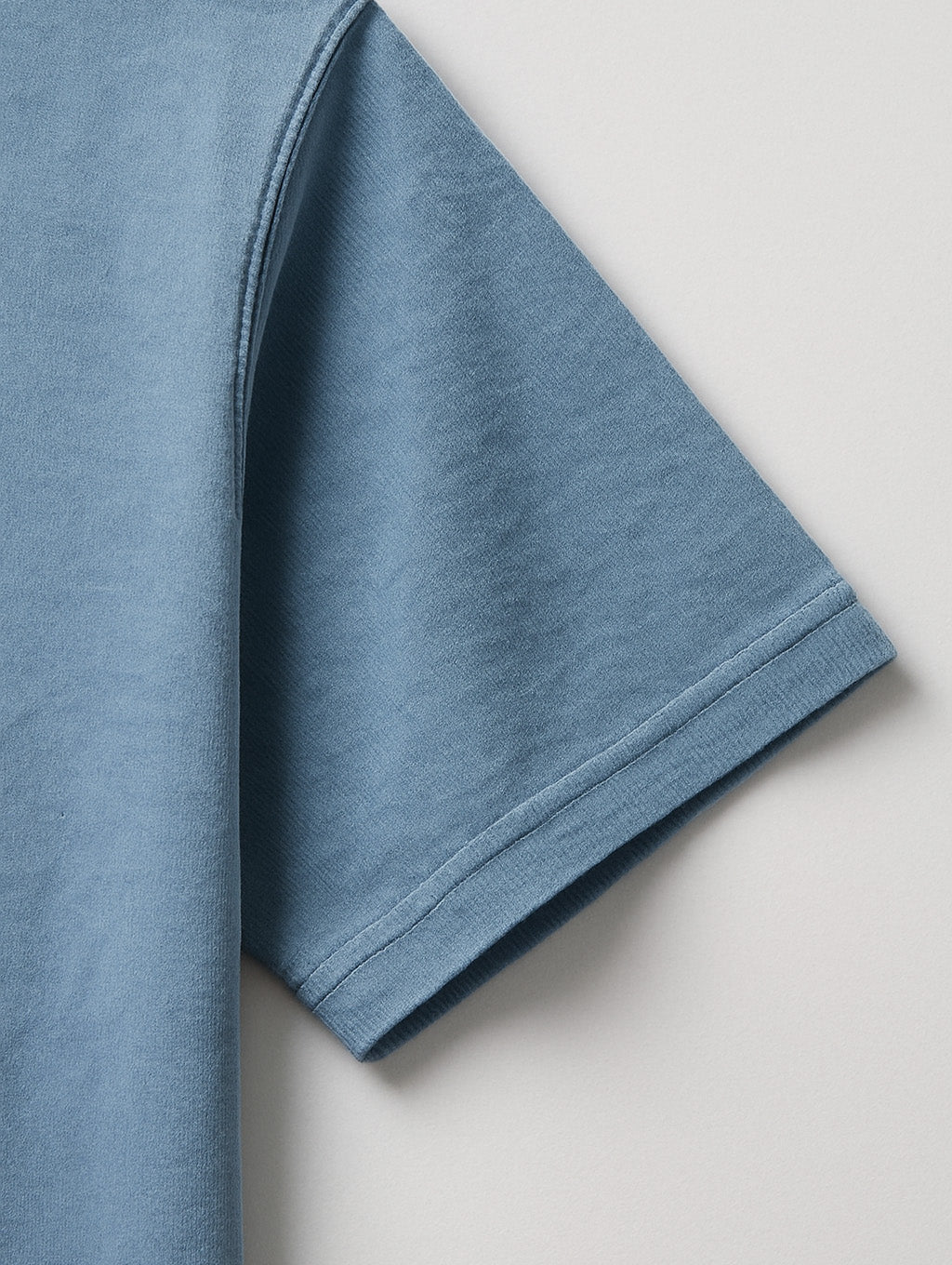 Close-up of sleeve stitching on Worn Denim Blue Zarvion vintage tee – double-needle hem on heavyweight cotton
