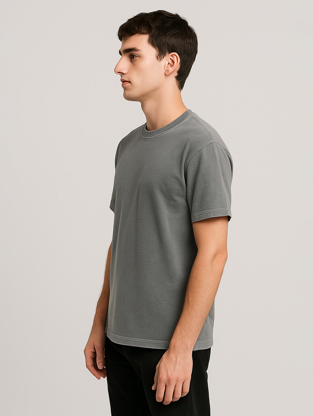 Side profile of male model in Ash Grey Zarvion tee – clean silhouette, garment-dyed cotton
